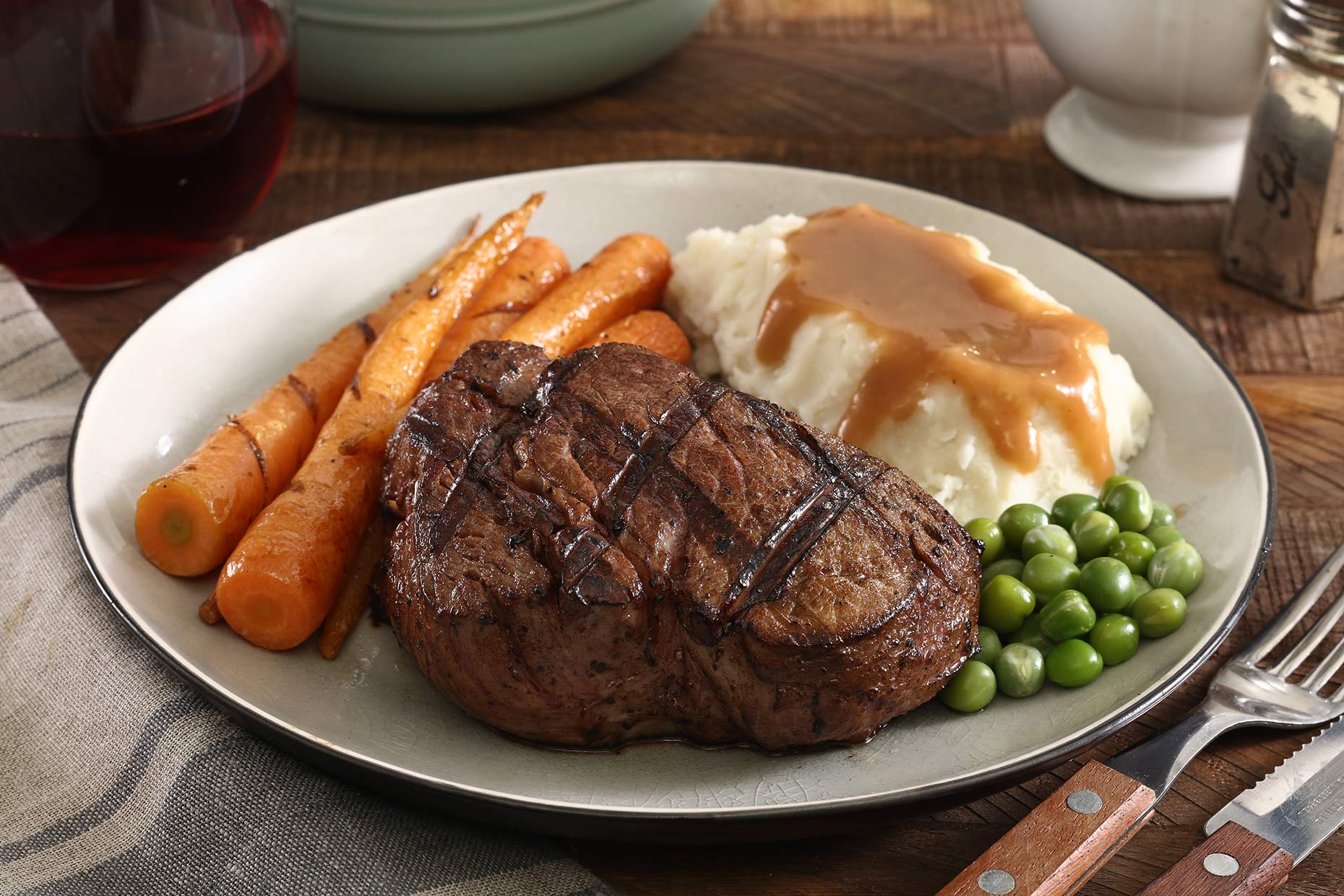 Filet mignon steak with mashed potato, carrots and peas.  Food photography for a meat  company in Manila.